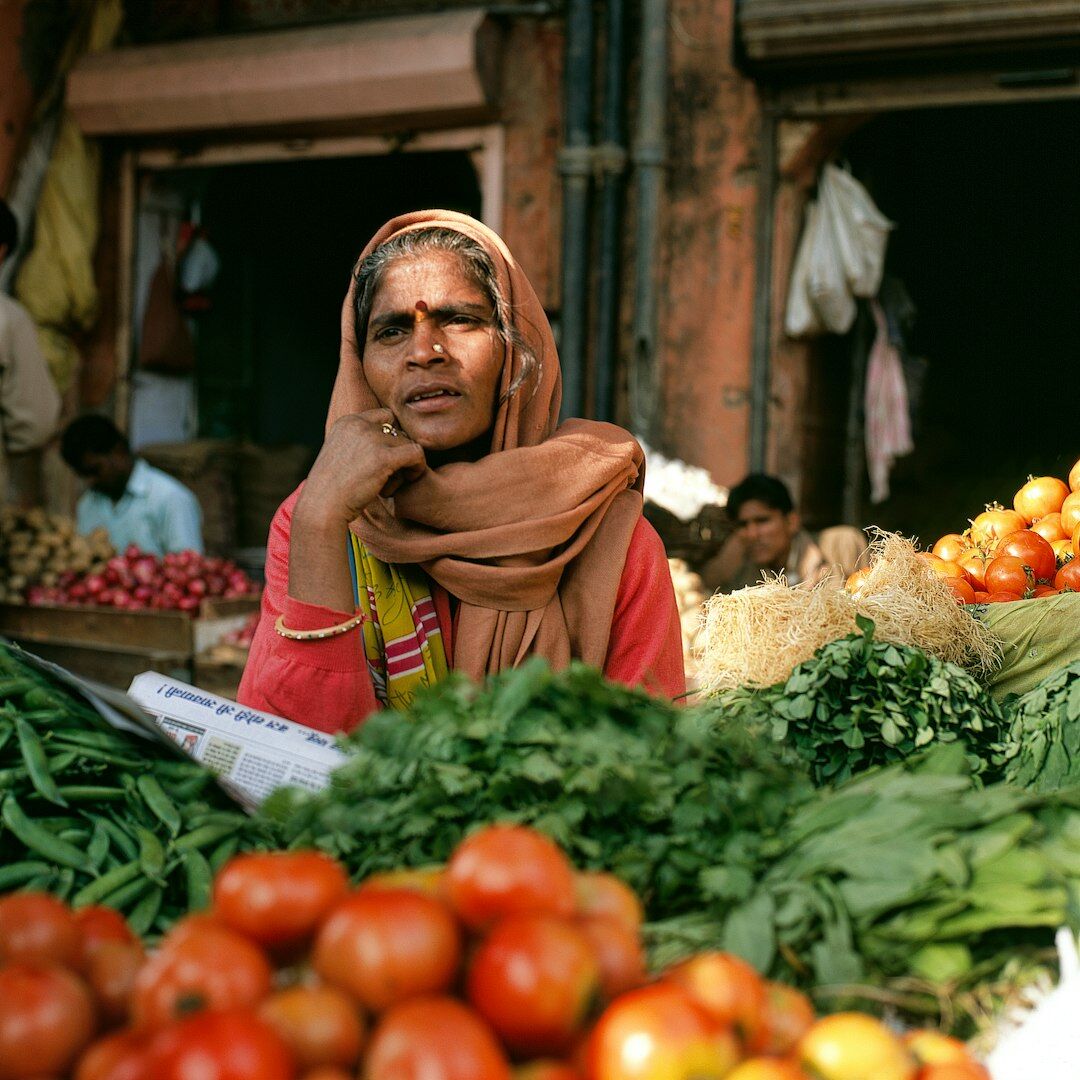 Portrait of a middle aged Danish woman selling vegetables at a local market