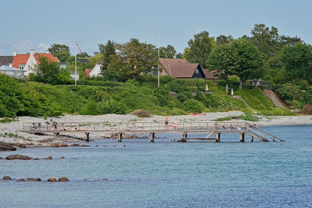 Fishermen mending nets on a wooden pier in a Danish coastal village