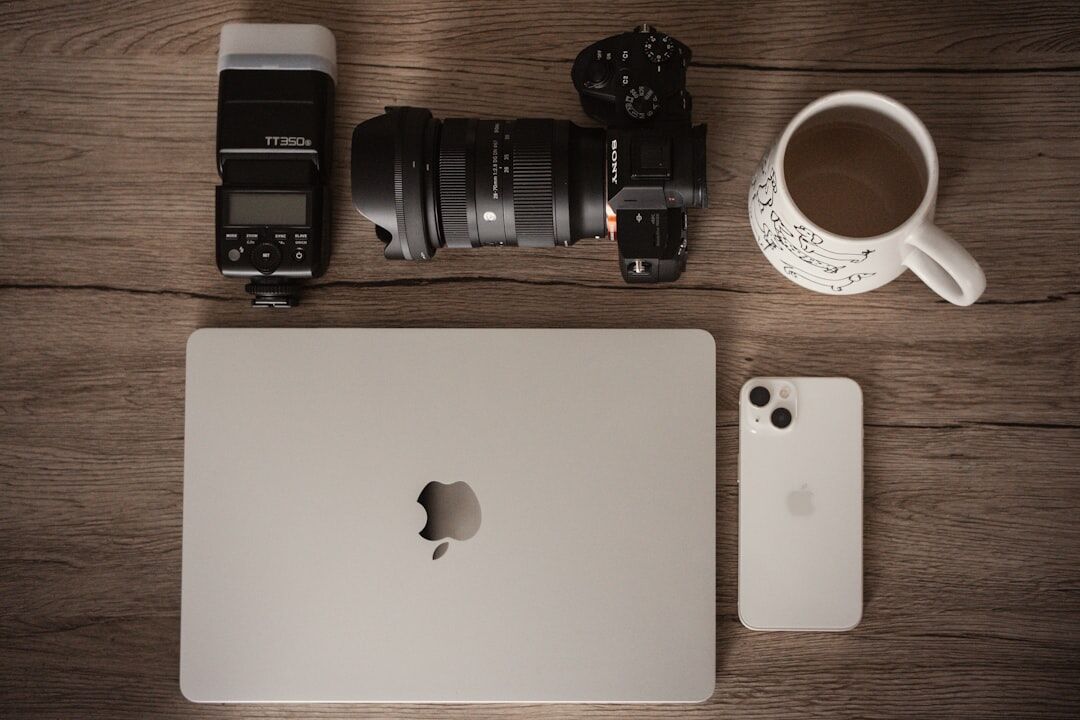 Camera equipment and notebooks arranged on a wooden desk in a photography studio