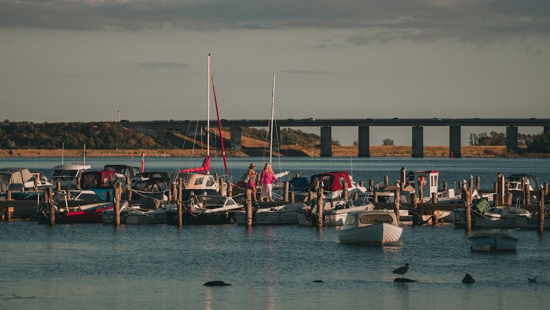Documentary photographer photographing fishermen at a Danish harbor at sunrise