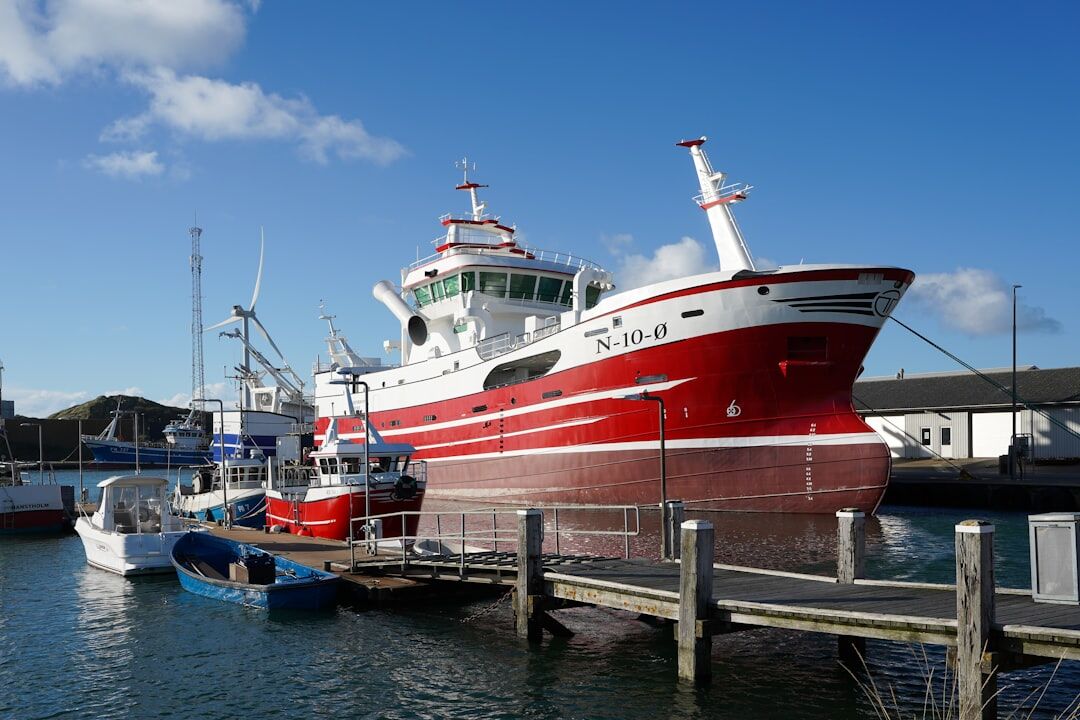 Dockworkers unloading fish crates at a Danish fishing harbor